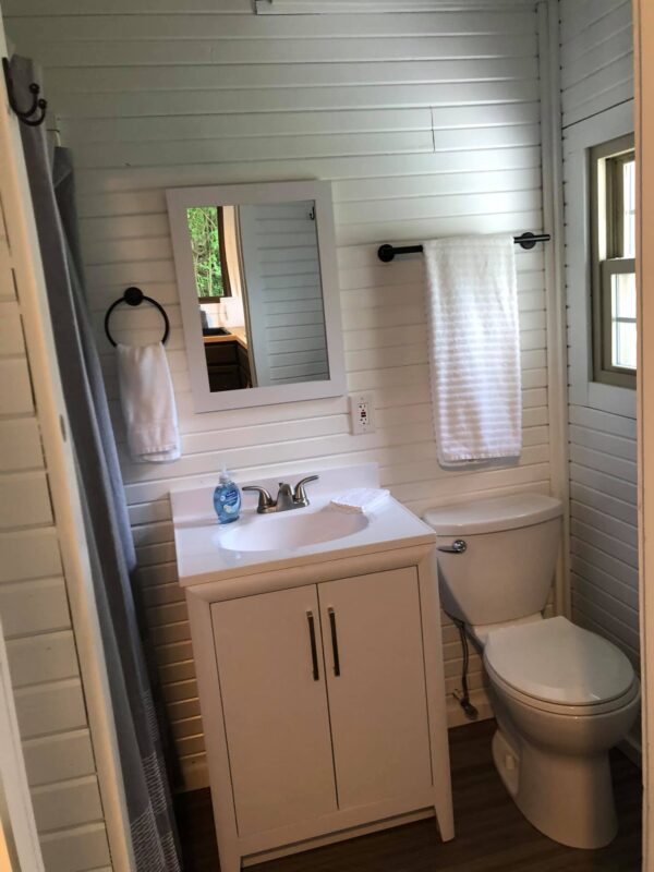 A bathroom with white walls and a toilet.