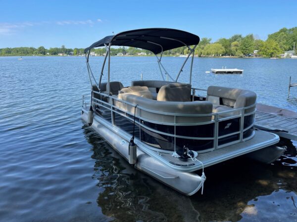 A boat with two seats and a canopy on the front.