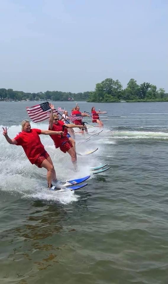 A group of people riding water skis on top of a body of water.