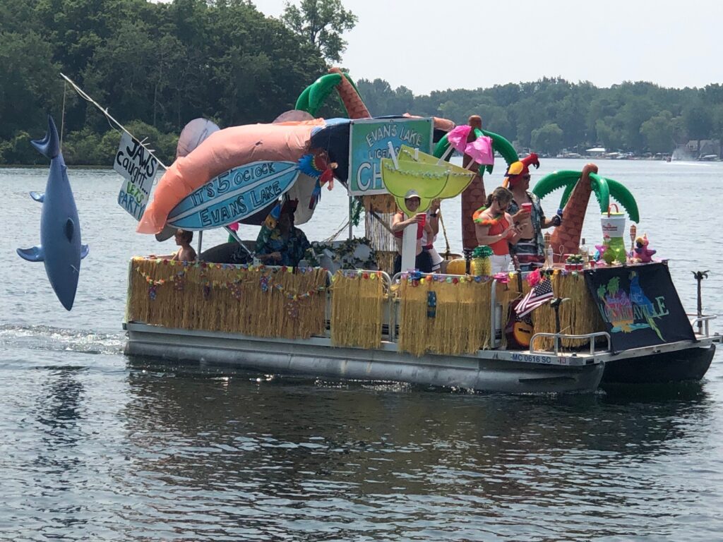 A boat with people on it floating down the river.